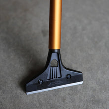 Load image into Gallery viewer, Ettore 4 inch carbon steel floor scraper removing debris from floor